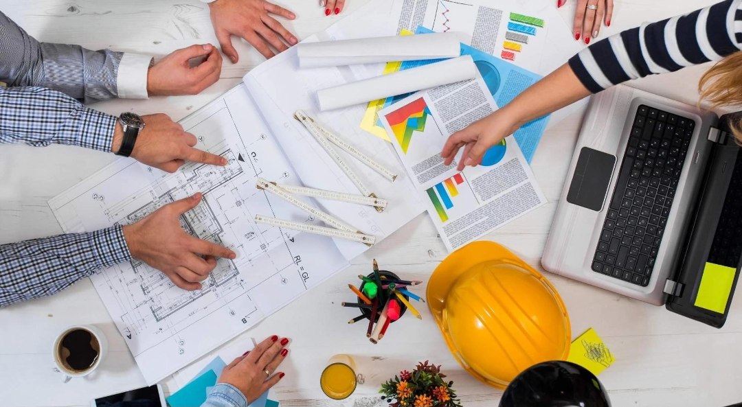 Site leadership team reviewing the day's work fronts on an Australian construction project